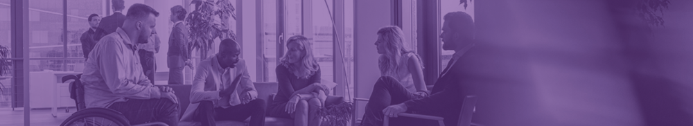 A conversation being had by several people, two sitting on a couch, one in a wheelchair, and two in chairs.