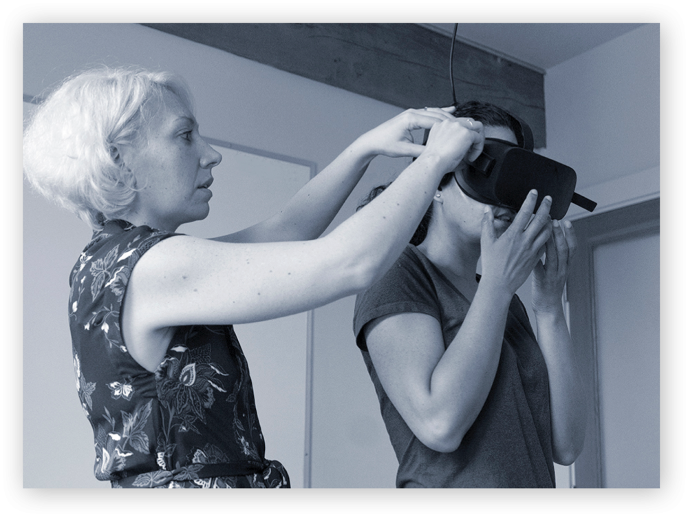 User researcher helps a UX research study participant don Oculus Rift headset