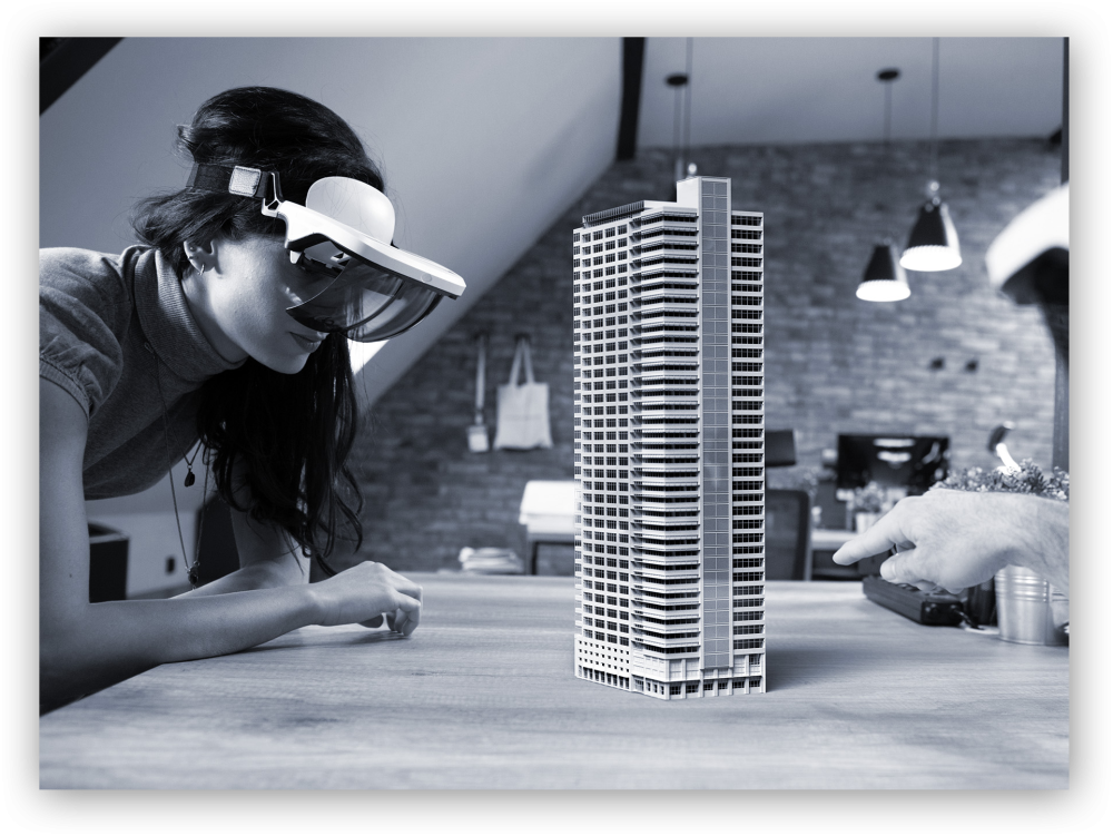 2 users wearing hololens headsets examine 3D holographic model of building