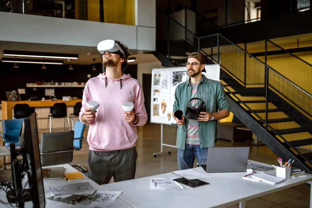 Two men standing in research center with one of them wearing a VR headset